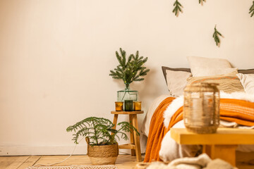 Christmas tree branches near the bed .Christmas interior. Christmas concept. Pillows, pine cones, gypsophila and fir tree branch