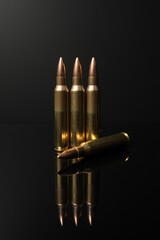 A row of calibre .223 5.56x45 rifle bullets. Automatic rifle ammo.