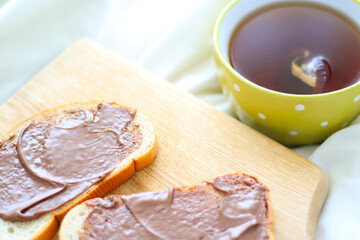 tea in a green mug and nutella bread