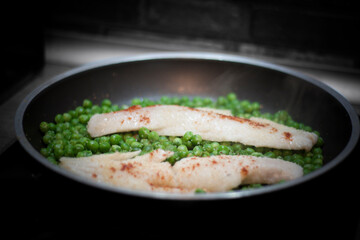 skillet with peas and hake