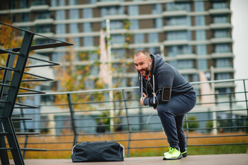 Young  jogger taking break from exercising outdoors