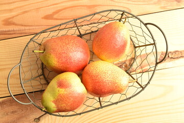 organic yellow-red pears, close-up, on a wooden table.