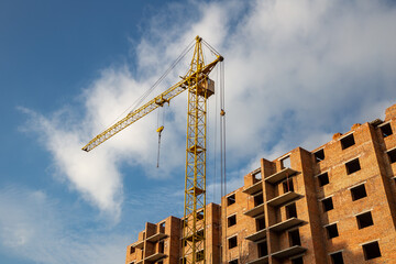 Work in progress on a new apartment block. Tall building under construction with cranes....