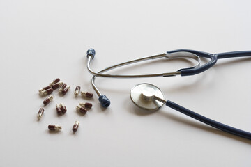 Stethoscope and pills on white background. Heart, lung care. Medicine, pharmaceutical concept.