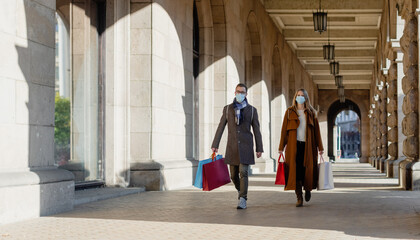 Couple doing their Christmas shopping wearing face masks