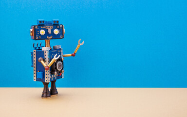 A smiling robot with a blue head and torso. A steampunk toy on blue background wall and a light beige floor. Free space for text and design.