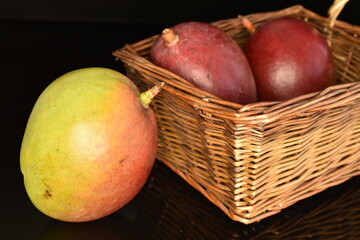 Fototapeta na wymiar ripe organic mango, close-up, on a black background.
