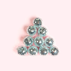 Party Disco balls on pastel pink background.