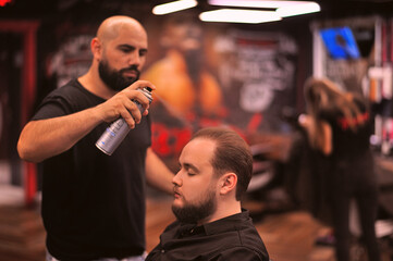 Brutal barber shaves a man in a barbershop