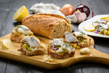 sandwiches with herring, onion and cucumber