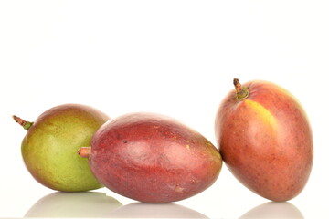 ripe organic mangoes, close-up, on a white background.