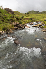 Fototapeta na wymiar Lotheni River flowing over rocks through green country side