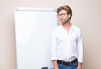 adult blonde businessman with a board