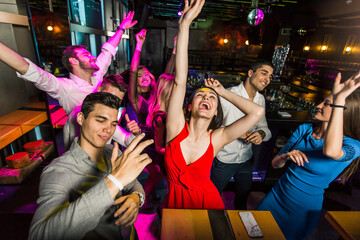 Young people dancing in night club