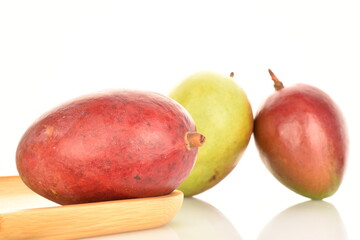 ripe organic mangoes, close-up, on a white background.