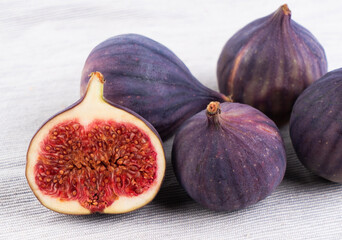 Ripe purple raw figs isolated on white background, whole and cut in half