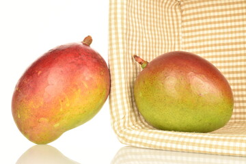 ripe organic mangoes, close-up, on a white background.