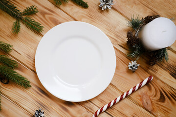 White plate Christmas mock up, New Year decorations, candles and tree