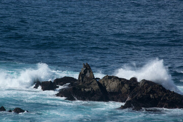 Ocean waves crashing onto a rocky shore