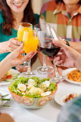 Group of mature people drinking juice at dinner at home
