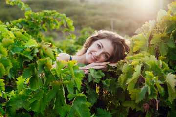 beautiful woman in dress with a glass of wine at a picnic in the vineyard