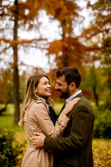 Young couple walking in the autumn park