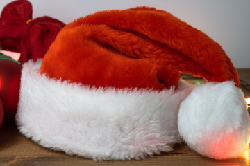 Obraz na płótnie Canvas Santa Claus red hat lying on the table, close up.