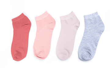 several colored new short socks on a white background, top view