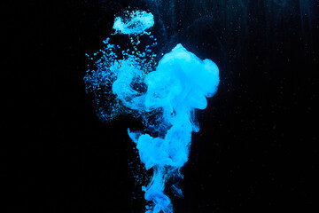 Blue paint in water. Unusual forms of abstraction