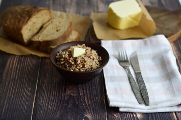 Bowl of tasty buckwheat porridge on wooden table.Healthy breakfast for schoolchildren.