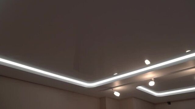 suspended ceilings and plasterboard structures in the decoration of an apartment or house. Dolly video. Led lighting.