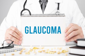 Doctor in a dressing gown holds a notepad with text Glaucoma, Medical concept
