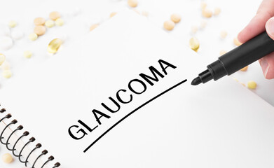 Doctor writes word Glaucoma on a white notepad