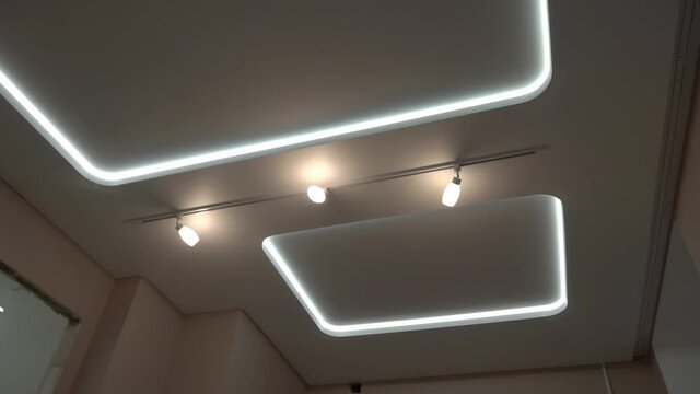 suspended ceilings and plasterboard structures in the decoration of an apartment or house. Dolly video. Led lighting.