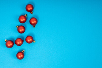 Red christmas balls on blue background. Christmas holiday celebration concept
