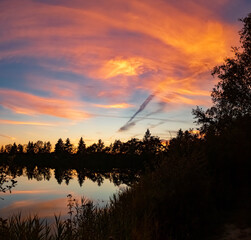 High resolution stitched panorama of a beautiful sunset with reflections near Tabertshausen, Bavaria, Germany