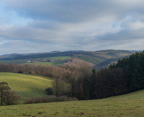 Beautiful landscape view hilly countryside fields with trees and forests