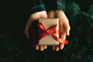 Holding Christmas gift in hand. Ideas for christmas decoration and gifts. Christmas and New year...