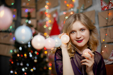 Close portrait of a cute lady with Christmas lights, looking at the camera