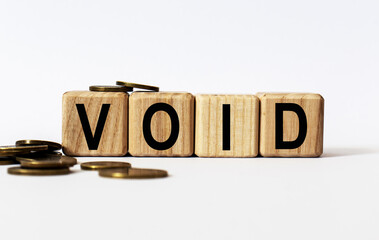 wooden cubes and VOID, coins, the concept of taxation, increase taxes and fees