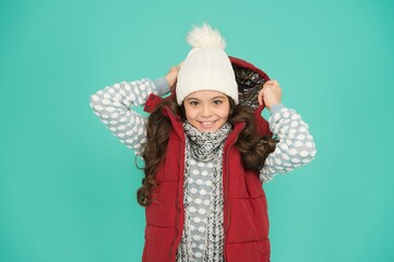 happy teen girl with long curly hair wear puffer waistcoat and knitwear on christmas holidays,...