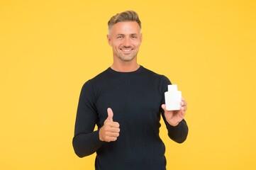 Happy caucasian man with unshaven facial hair in casual style show thumbs ups hand gesture holding...