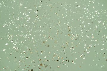 Festive background in olive color with holographic flying silver sparkles for your project. Holiday...