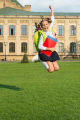 Spare time. Energetic kid jump in schoolyard. School holidays. Happy pupil in midair. Graduation day. Primary education. Celebrating holidays. Summer vacation