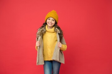 happy teen girl in knitted sweater and hat wear warm clothes in winter season, fashion