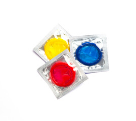Close up shot of various colored condoms. A condom use to reduce the probability of pregnancy or...