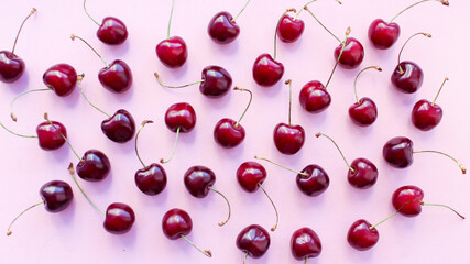 Naklejka na ściany i meble ripe sweet red cherry on a pink background. Healthy food. minimalism