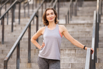 Slim fit adult woman exercise on an outdoor workout training alone. Summer sunset morning portraits in action on a european streets with space for text.