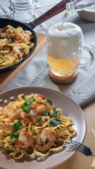 pasta with shrimps and beer in a glass