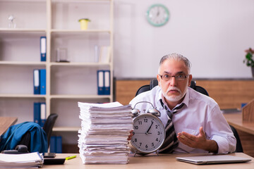 Old male employee unhappy with excessive work in the office